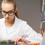 front-view-female-technician-with-electronics-board-soldering-iron