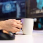 Close up man holding coffee mug talking with artificial intelligence