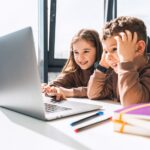 Boy and girl at laptop. Distance education