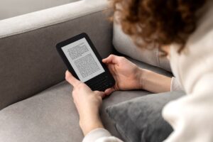 High angle man reading digital magazine