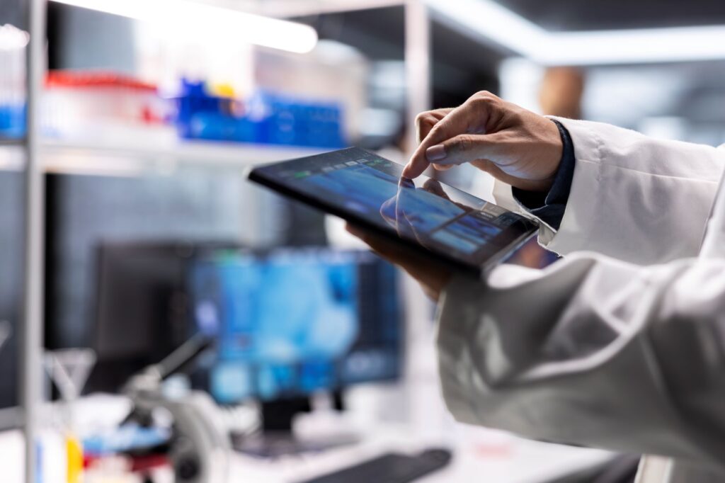 Close up researcher laboratory performing biochemistry tablet working molecular testing